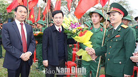 Đồng chí Phạm Đình Nghị, Phó Bí thư Tỉnh ủy, Chủ tịch UBND tỉnh tặng hoa, động viên tân binh Thành phố Nam Định lên đường nhập ngũ.