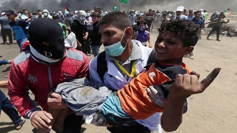 Một trẻ em bị thương trong cuộc xung đột giữa người biểu tình Pa-le-xtin và binh sĩ I-xra-en tại dải Ga-da. Ảnh: Reuters