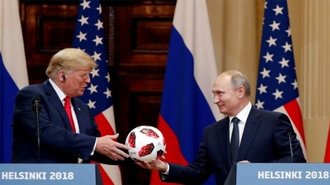 Tổng thống Nga Putin tặng Tổng thống Mỹ Trump trái bóng World Cup 2018 khi hai nhà lãnh đạo tiến hành họp báo chung tại Helsinki, Phần Lan, ngày 16-7. (Ảnh: Reuters)