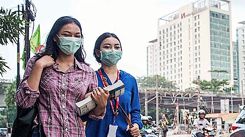 Người dân thành phố Jakarta (Indonesia) đeo khẩu trang tránh khói bụi. Ảnh: NOW JAKARTA