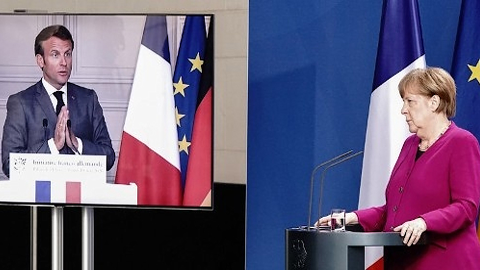: Tổng thống Pháp và Thủ tướng Đức thông báo về kế hoạch 500 tỷ euro tại cuộc họp báo trực tuyến chung ngày 18-5. Ảnh: Le Monde - AFP.