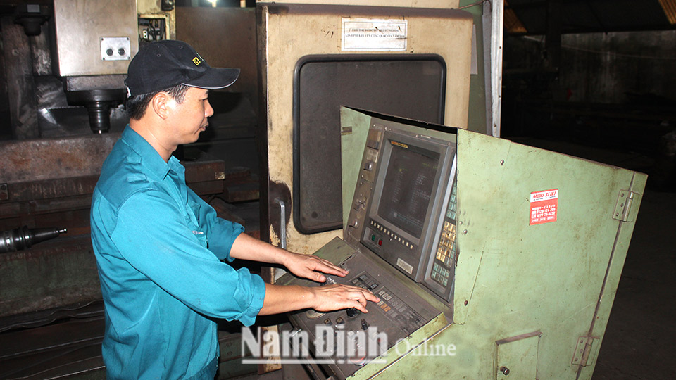 Công nhân Công ty TNHH Cơ khí Đình Mộc (Xuân Trường) sử dụng máy tiện CNC hiện đại.