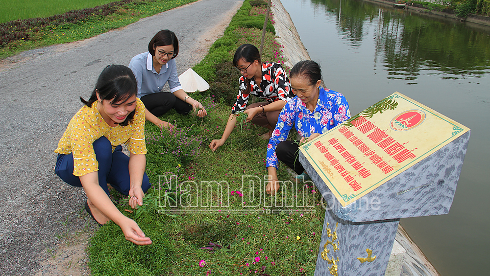 Cán bộ Phụ nữ xã Hải Châu (Hải Hậu) chăm sóc tuyến đường hoa kiểu mẫu (Ảnh chụp trước ngày 27-4-2021). Ảnh: VĂN TRọNG