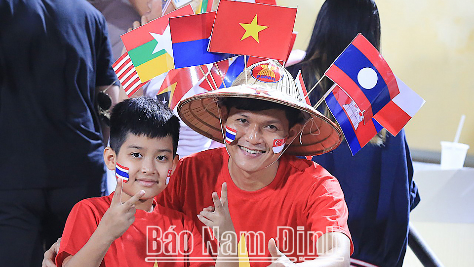 Các cổ động viên mặc áo cờ đỏ sao vàng Việt Nam cổ vũ trận đấu.