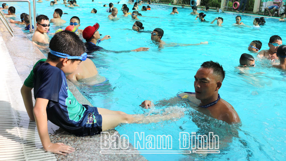 Thầy giáo Lưu Đức Quân đang dạy bơi cho học sinh mới.