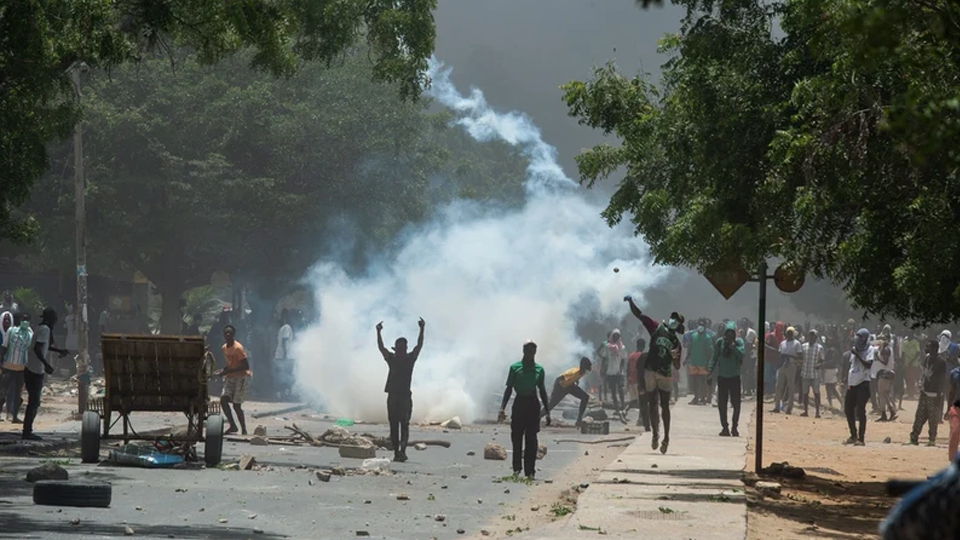 Người biểu tình quá khích ném đá về phía cảnh sát tại Dakar, Senegal, ngày 1/6/2023. Ảnh: AFP/TTXVN
