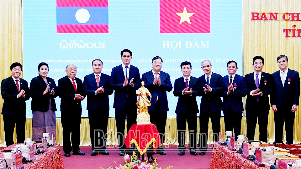 Các đồng chí lãnh đạo tỉnh Nam Định tặng Đoàn đại biểu tỉnh U Đôm Xay bức tượng Quốc công Tiết chế Hưng Đạo Đại vương Trần Quốc Tuấn. 
