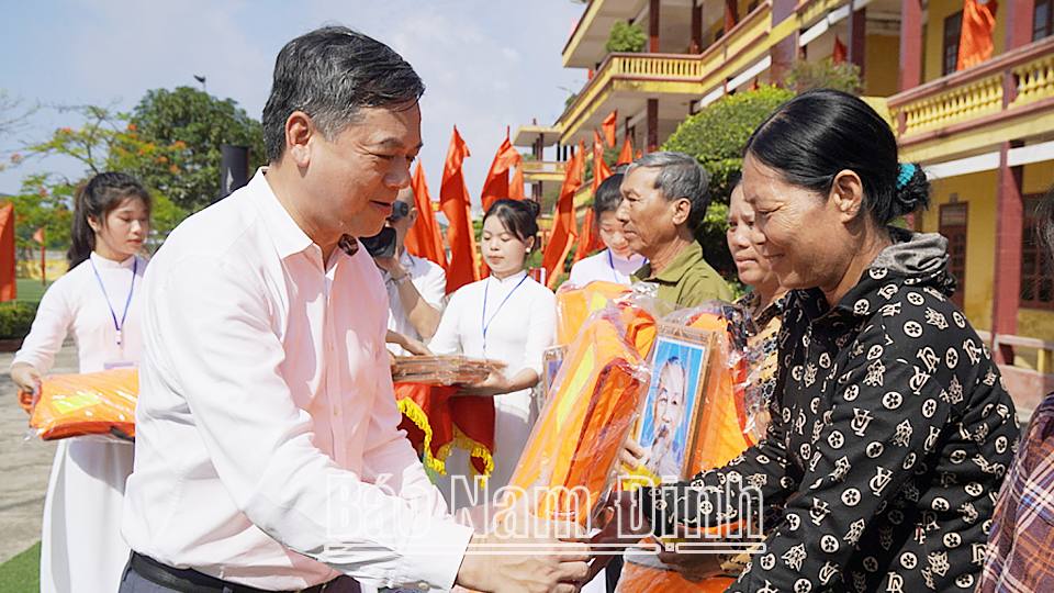 Đồng chí Trần Lê Đoài, TUV, Phó Chủ tịch UBND tỉnh trao tặng 30 áo phao, cờ Tổ quốc, ảnh Bác Hồ cho ngư dân huyện Hải Hậu.