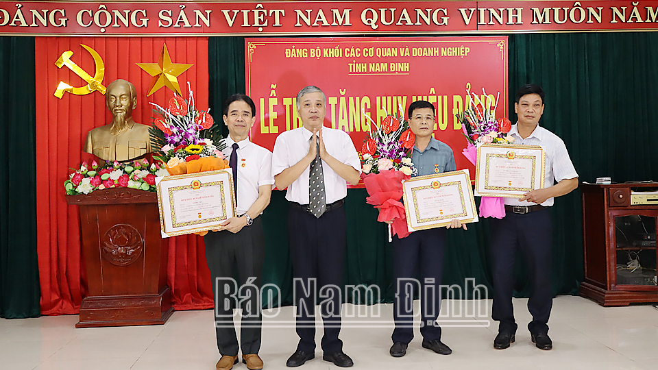 Đồng chí Nguyễn Tài Sơn, Phó Bí thư thường trực Đảng ủy Khối Các cơ quan và Doanh nghiệp tỉnh trao tặng Huy hiệu 40 năm tuổi Đảng cho các đảng viên. 
