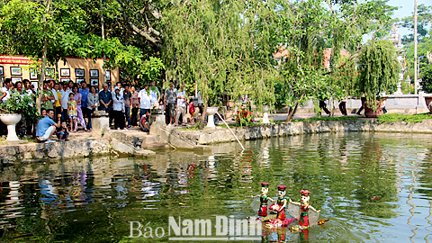 Đoàn múa rối nước Sông Quê biểu diễn trong dịp Lễ hội Đền Trần 2016 thu hút đông đảo người xem.