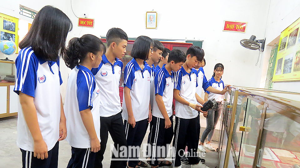 Học sinh Trường Trung học phổ thông Quang Trung (Nam Trực) tìm hiểu truyền thống lịch sử địa phương tại phòng truyền thống của nhà trường.