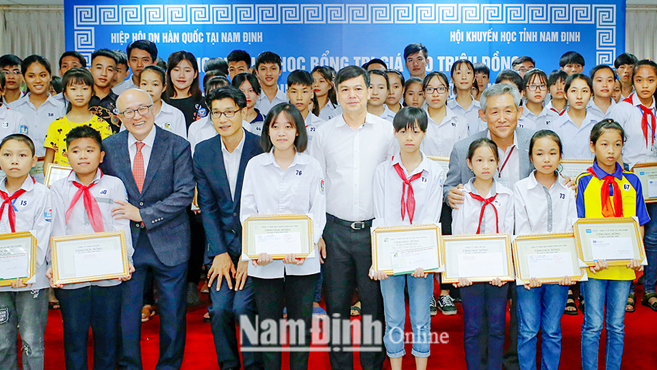 Đồng chí Trần Lê Đoài, Tỉnh ủy viên, Phó Chủ tịch UBND tỉnh chụp ảnh lưu niệm cùng các học sinh, sinh viên được trao học bổng vượt khó hiếu học năm 2019.
