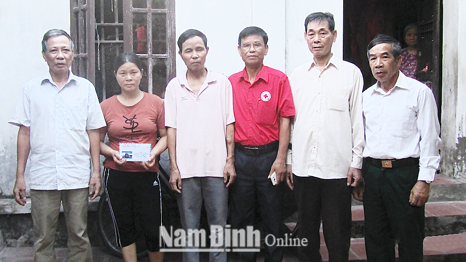 Ông Phạm Văn Thành (thứ 4 từ trái qua) trao tặng quà cho người nghèo trên địa bàn xã Phương Định (Trực Ninh). Ảnh: Do cơ sở cung cấp