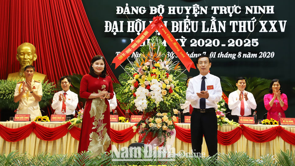 Đồng chí Phạm Đình Nghị, Phó Bí thư Tỉnh ủy, Chủ tịch UBND tỉnh trao tặng đại hội lẵng hoa tươi thắm.    ảnh: Hoàng Tuấn